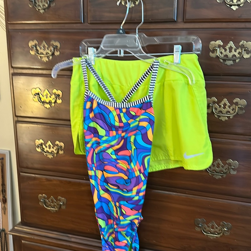 Women’s one piece swim suit with matching swim shorts.
